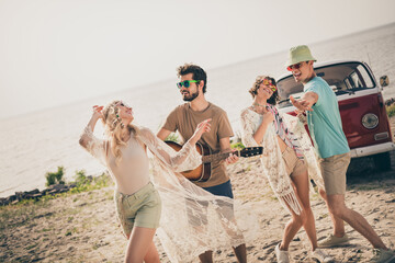 Photo of four carefree crazy hipster buddies enjoy beach party discotheque wear casual outfit nature seaside beach outside