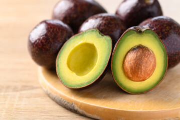 Ripe avocado fruit ready to eating on wooden board