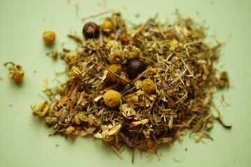 tea collection of dry herbs and flowers on green table