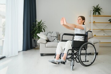 Brunette woman working out on wheelchair at home