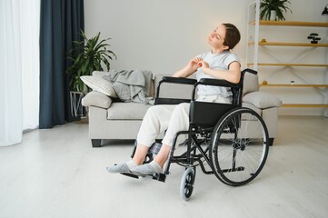 Woman in wheelchair working out in living room