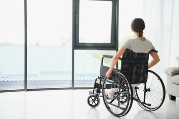 Fototapeta na wymiar Young woman sitting in a wheelchair