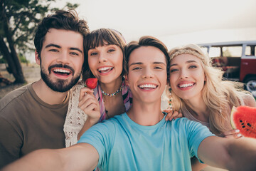 Portrait of positive hippie fellows enjoy seaside weekend make selfie hold berry water melon outside