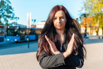 Pretty business woman with her arms crossed at her chest demonstrates break the bias symbol of...