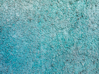 The wall is covered with light emerald concrete plaster.