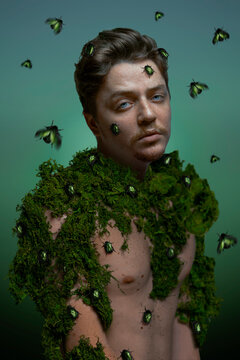 Beautiful man with green bettles on his face