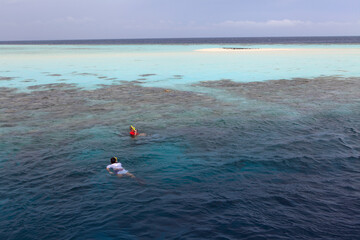 People snorkeling at Filitheyo island, Maldives