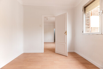 Fototapeta na wymiar Empty living room with white painted walls with aluminum window, white woodwork and light oak flooring