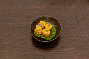 shaomai is also known as pork and mushroom dumpling, Its filling is a combination of ingredients, consisting primarily of seasoned minced pork, minced and whole shrimp, and finely chopped shiitake