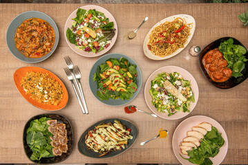 Set of healthy food dishes with fresh fruits, vegetables on a natural oak wooden table