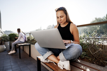 Young blonde businesswoman using laptop working at the terrace in Istanbul
