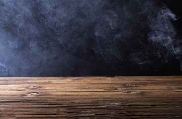 Wooden floor or table with white fog or smoke. on a black background