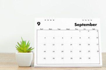 September 2022 desk calendar on wooden background.
