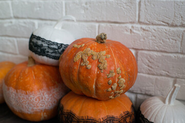 Ugly autumn pumpkins on the black floor