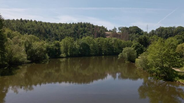 Lush and leafy nature along the river banks of the sieg in North Rhine Westphalia, Germany. Low aerial fly along shot