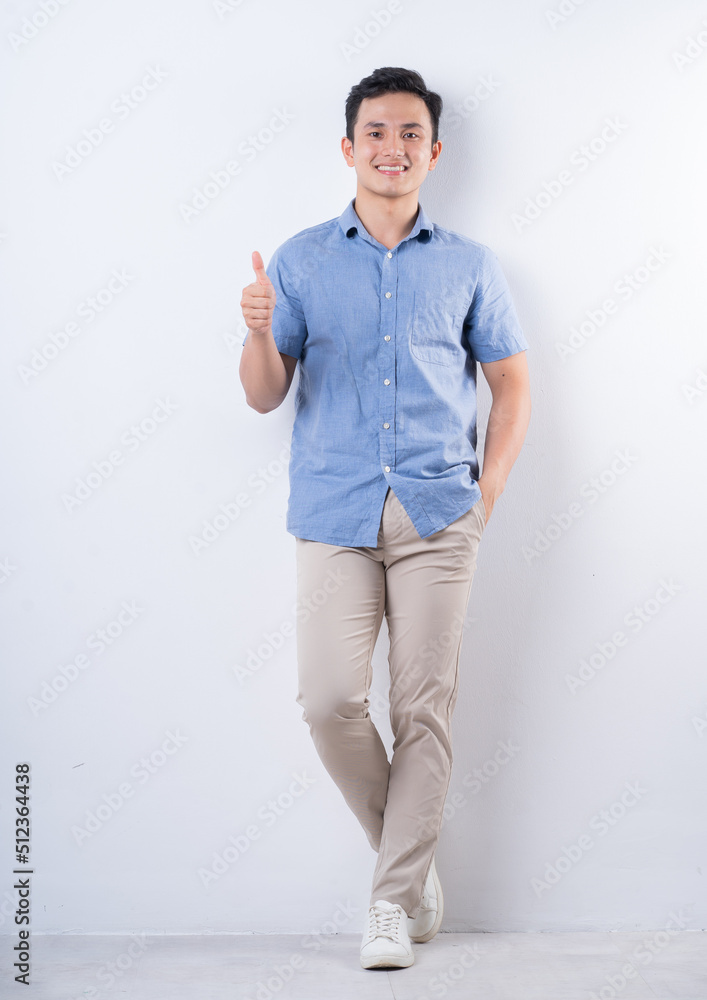 Wall mural full length image of young asian man on white background