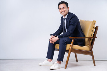 Image of young Asian businessman on background
