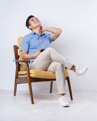 Image of young Asian man sitting on chair