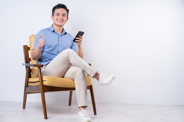 Image of young Asian man sitting on chair - Powered by Adobe