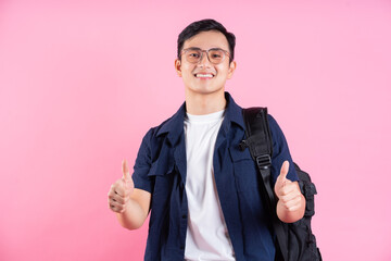Image of young Asian college student on pink background