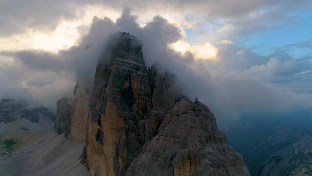 Aerial view moody clouds covering landmark Tre Cime South Tyrol Dolomites mountain peak rock formation