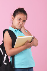 School girl holding notebook and carrying backpack with angry expression