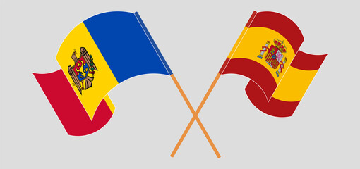 Crossed and waving flags of Moldova and Spain