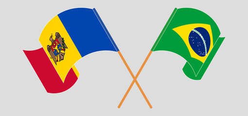 Crossed and waving flags of Moldova and Brazil