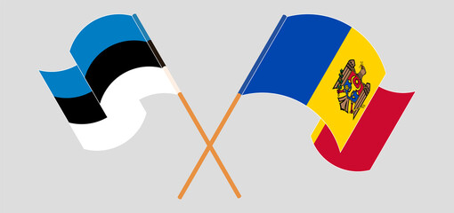 Crossed and waving flags of Estonia and Moldova