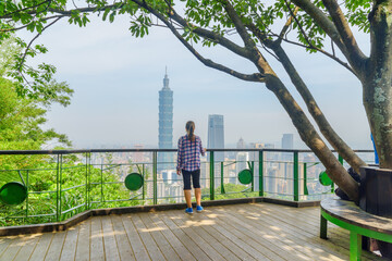 Young female tourist enjoying awesome view of Taipei, Taiwan