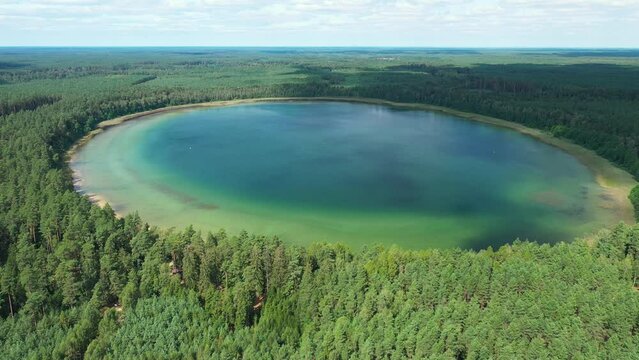 Lake in the forest aerial drone shot - Plaskie lake Poland	