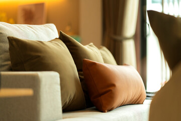 contemporary interior of Living room with part of sofa and arrange set of decorate pillow in sunny...