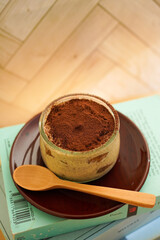 Tiramisu made with biscuits and mascarpone cheese on the book