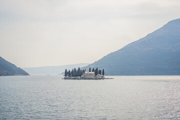 St George Island in the Bay of Kotor at Perast in Montenegro, with St George Benedictine Monastery. St. George Island, is a small natural island off the coast of Perast in Bay of Kotor, Montenegro
