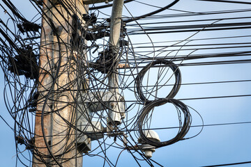 Messy or disorder electricity and telecommunication cable lines which are alignmented on the same...