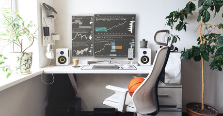 Comfortable home office of a trader with several monitors in bright colors.