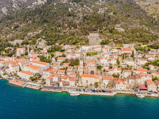 Scenic panorama view of the historic town of Perast at famous Bay of Kotor with blooming flowers on...