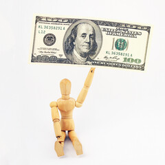 One hundred us dollars banknotes and wooden man