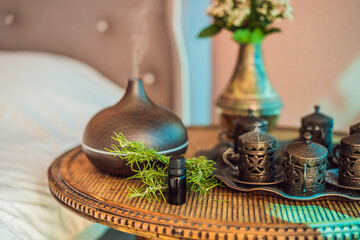 Obraz na płótnie Canvas Aroma oil diffuser with aroma oil on table at home. Air freshener