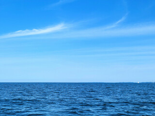 Fototapeta na wymiar Blue Lake Michigan water with horizon and summer sky