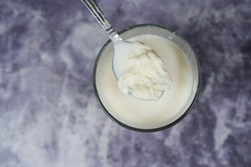 glass of whole cream milk on table , Cream of milk.