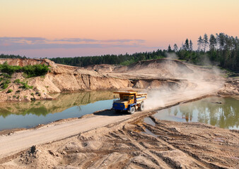 Mining excavator loads sand into dump truck. Excavator loads sand rock into a haul truck. Sand pit development. Mining industry. Electric rope shovel dropping rock ore. Sand mining in opencast. © MaxSafaniuk