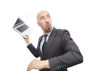 A man in suit not happy with the result throws a laptop isolated on white background.