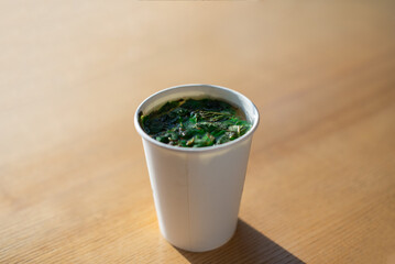 Peppermint tea in a disposable white cup