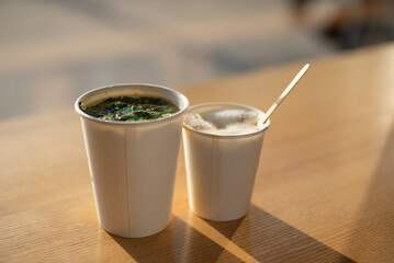 Peppermint tea in a disposable white cup
