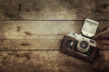 Retro camera on a wooden vintage background