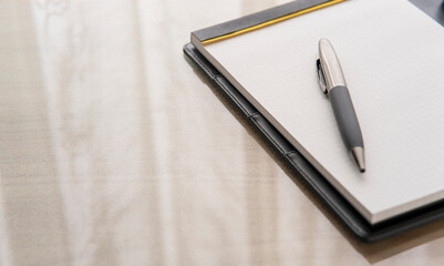 Pen and Notepad on the desk for template. Notepad .Blank paper for annotation. Pen on the notepad.