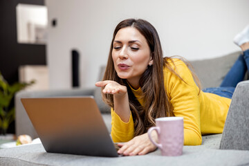 Fototapeta premium Woman using her laptop at home