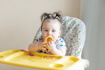 baby eats mashed potatoes from a jar, baby food concept