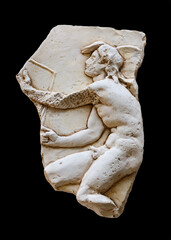 Ancient decoration element with sculpted man isolated on black. Elements of architectural decorations of buildings, gypsum stucco, On the streets in Jelsa, island Hvar, Croatia, public places